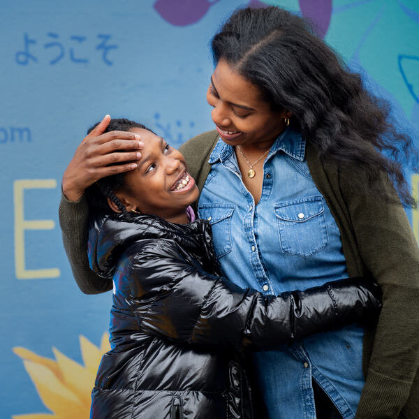 Mother and daughter embracing with fond smiles